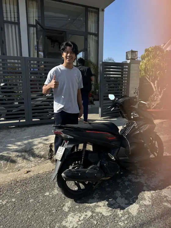 Довольный гость с чёрным Honda Air Blade у гестхауса в Далате
